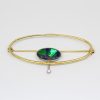 Solid boulder opal brooch set in 18ct yellow and white gold with diamond