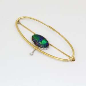 Solid boulder opal brooch set in 18ct yellow and white gold with diamond