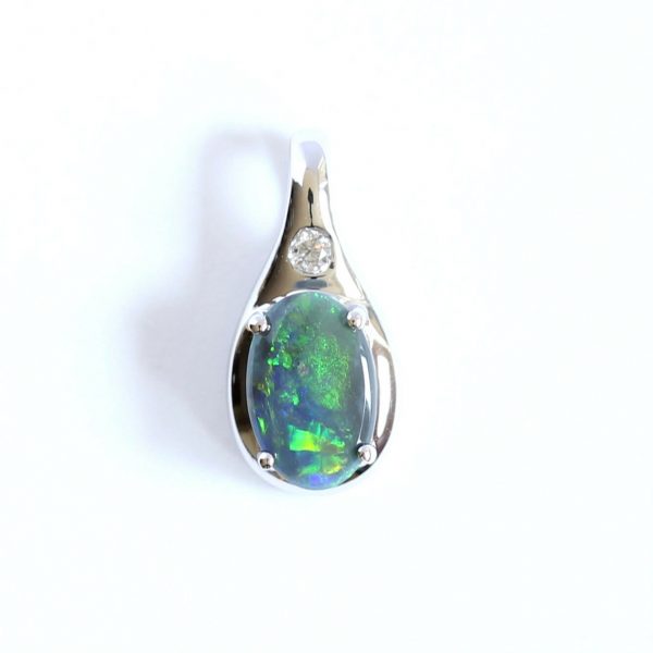  Solid black 0.47ct opal pendant set in 18ct white gold with diamond