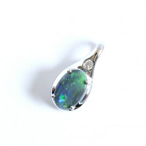  Solid black 0.47ct opal pendant set in 18ct white gold with diamond